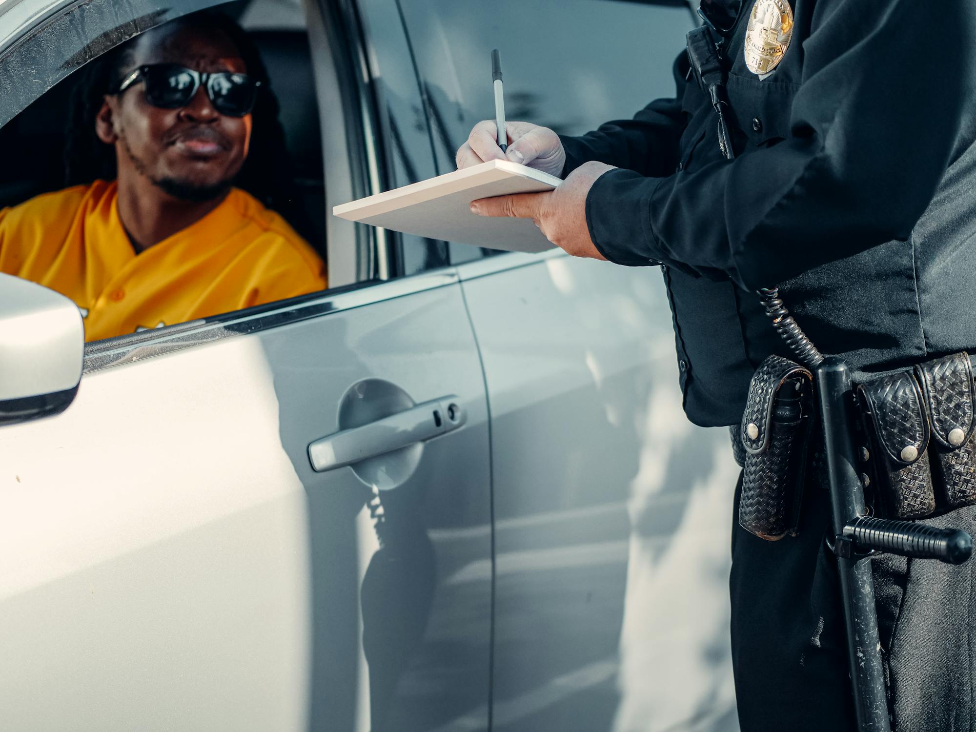 Man Looking at the Police Officer Writing
