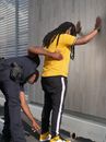 Policeman Frisking the Person in Yellow Shirt