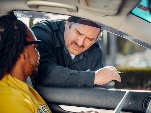 Man Talking to the Person Inside the Car 