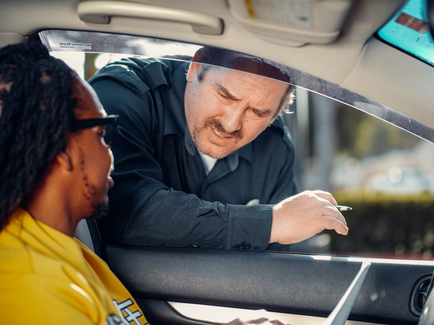 Officer communicating with a driver through a car window