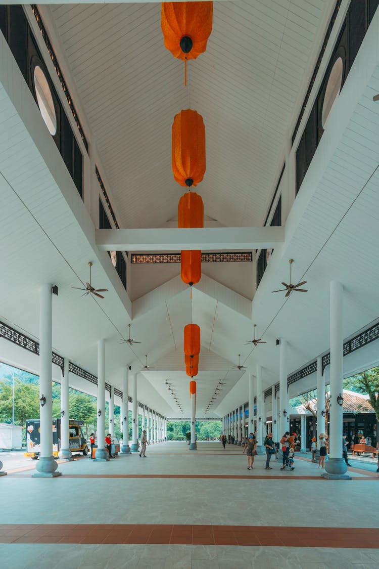 Red Paper Lanterns Hanging On The Ceiling Of White Concrete Building 