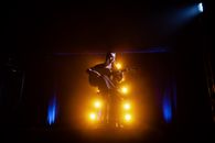 Man in Black Shirt Playing Guitar on Stage