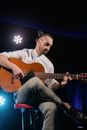 Man in Gray Shirt Playing Guitar