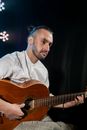 Man in White Dress Shirt Playing Guitar