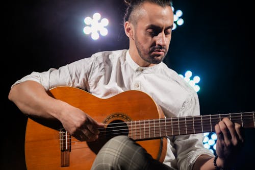 Bearded Man Playing a Guitar