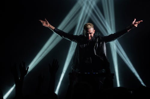 Free Man in Black Leather Jacket Standing on Stage Stock Photo