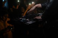 Person Playing Dj Mixer in Room