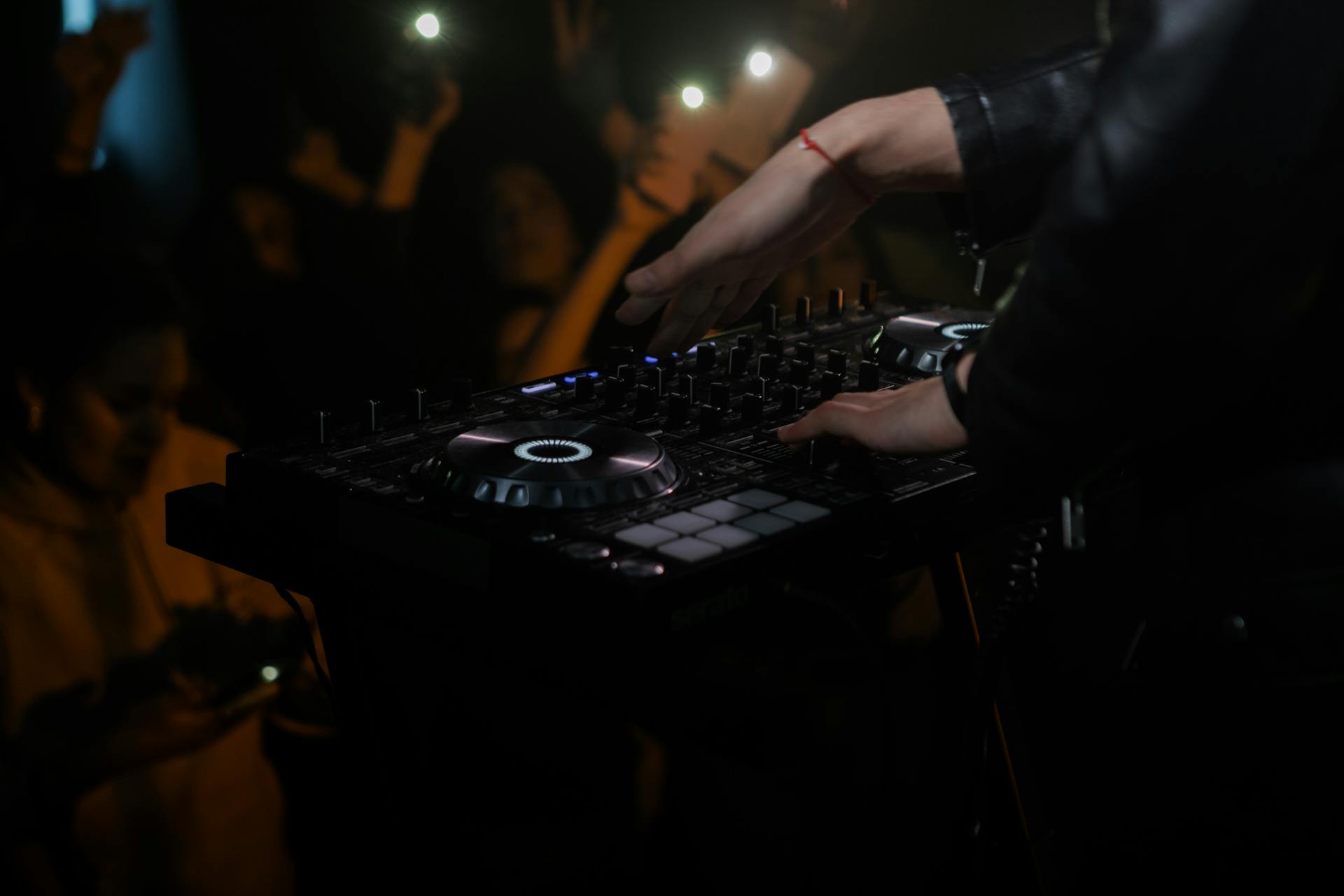 Person Playing a Dj Mixer on Stage