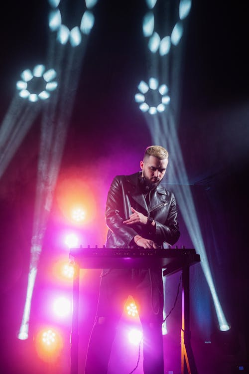 Free Man in Black Jacket Performing on Stage Stock Photo
