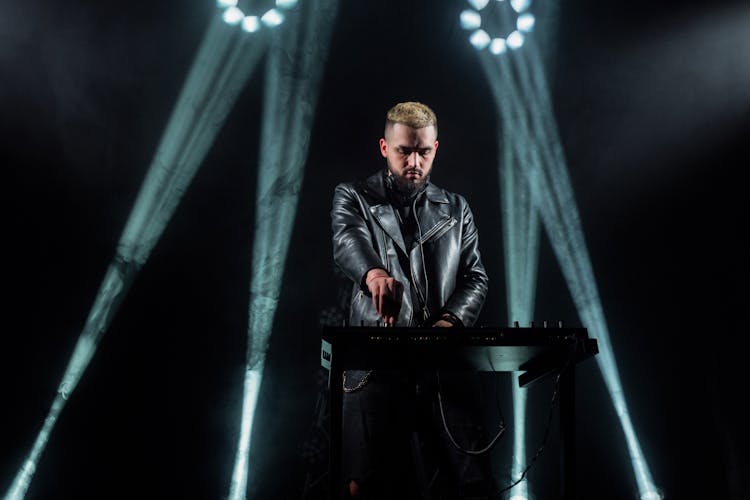 Man In Black Leather Jacket Performing On Stage