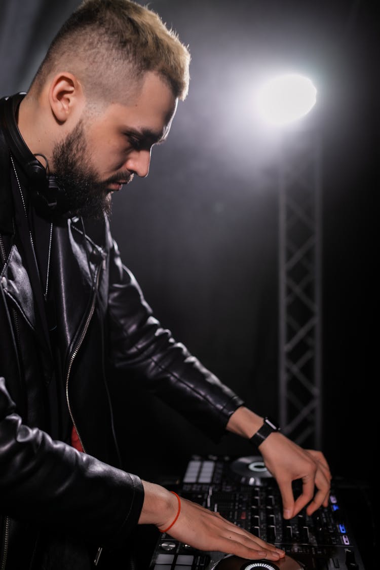 A Male DJ In Black Leather Jacket