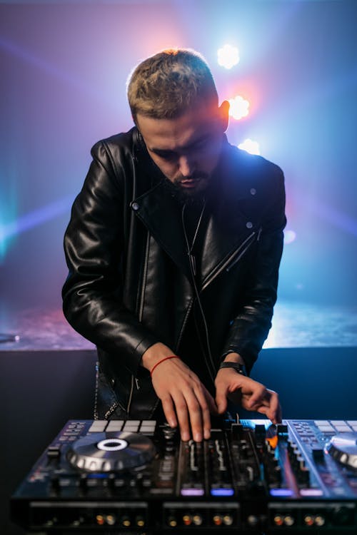 Free Man Wearing Black Leather Jacket Using DJ Mixer Stock Photo