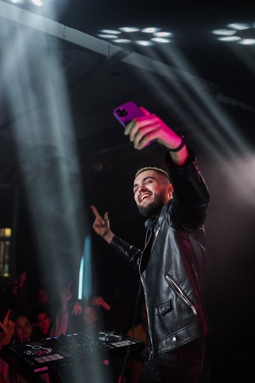 Disc Jockey on Stage Taking Selfie