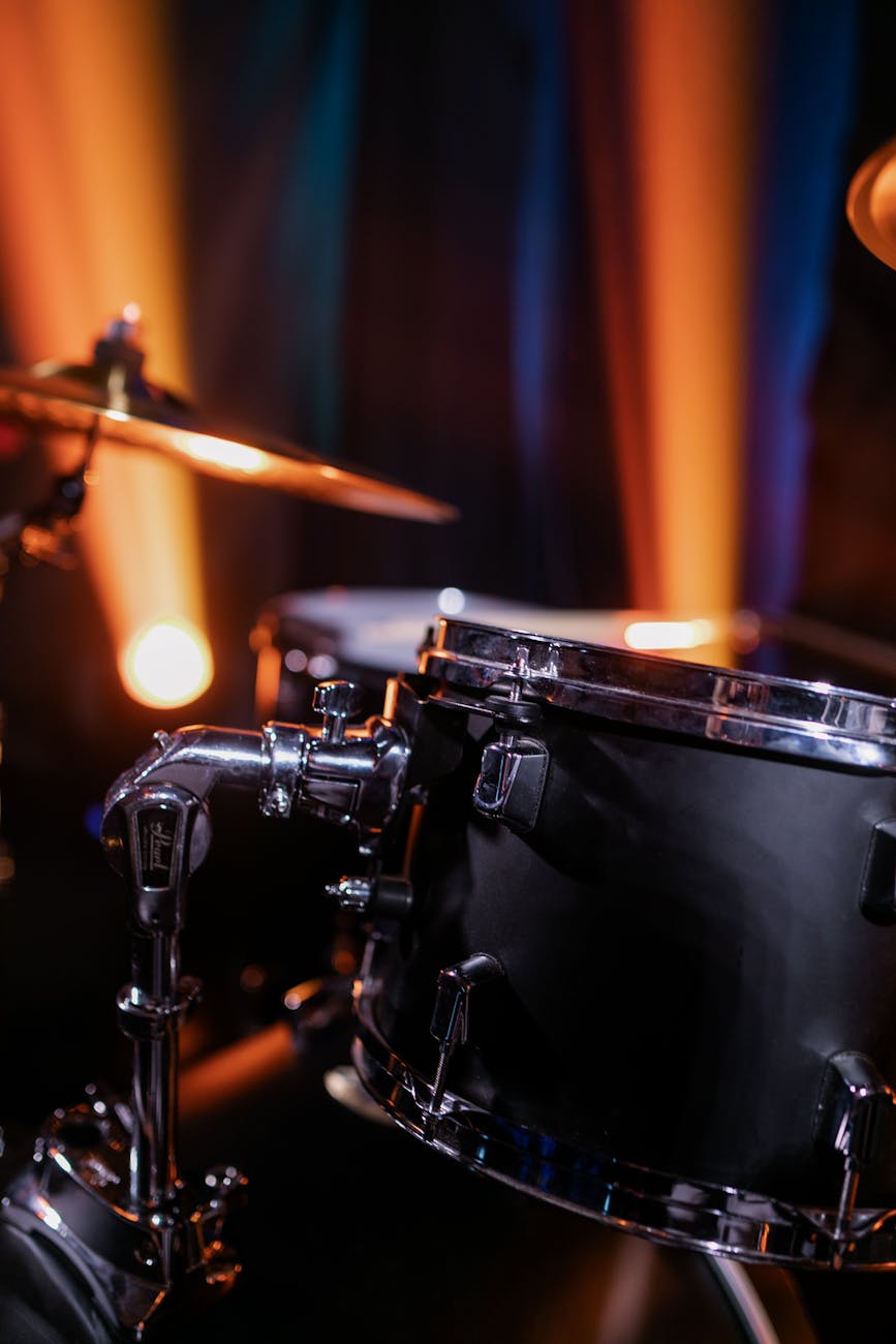 Black Drum Set Near Red and Yellow Light · Free Stock Photo