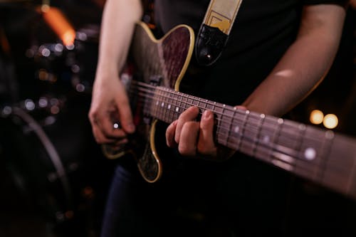 Free Person Playing Brown and Black Electric Guitar Stock Photo