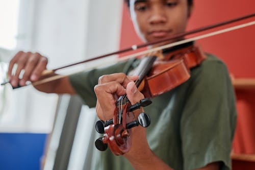 Person Green Shirt Playing Violin