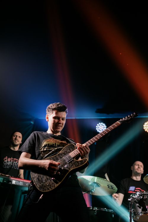 Free Dynamic live band performance featuring a passionate guitarist on stage. Stock Photo