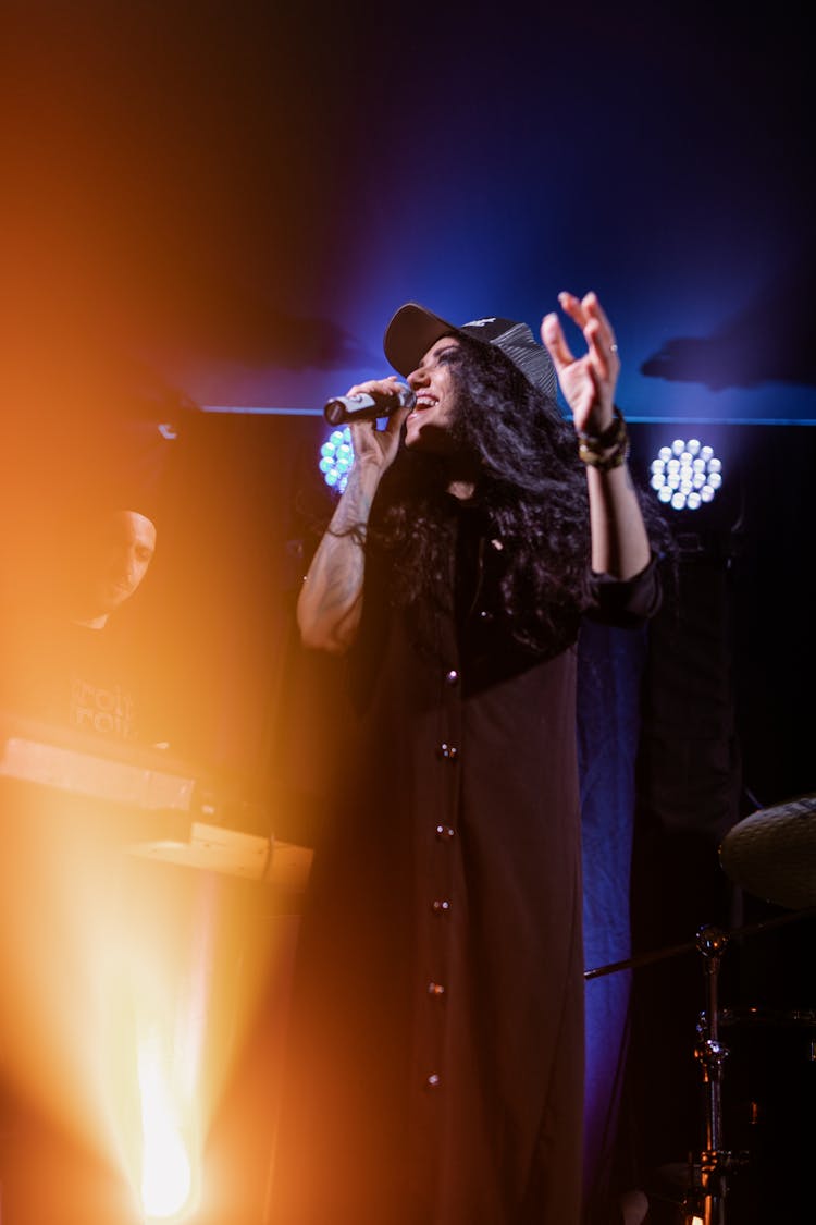 A Woman Singing On The Stage