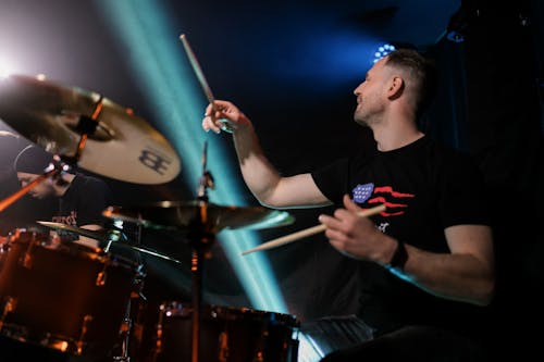 A Man Playing Drums at a Concert