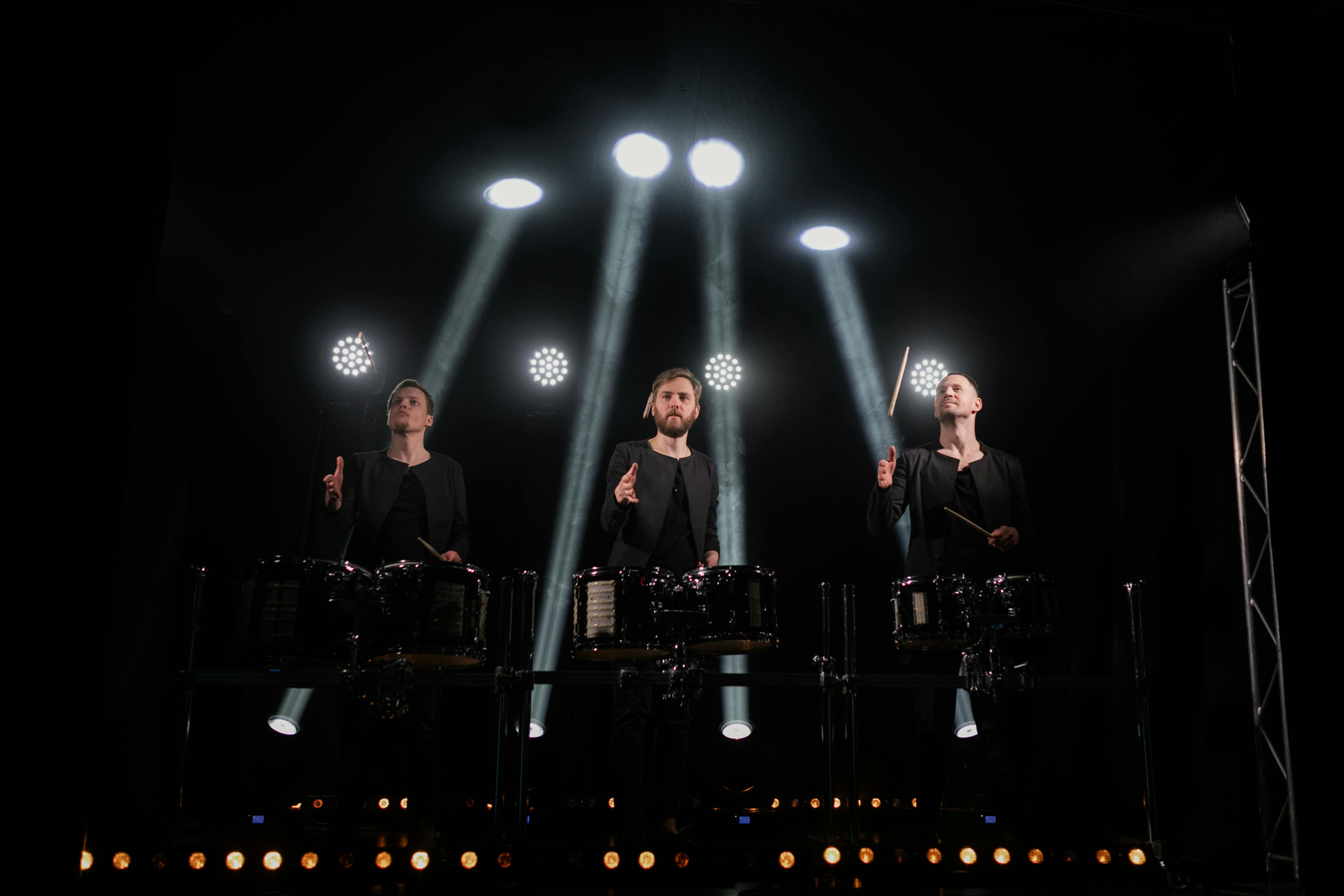 young artists playing drums on stage during show