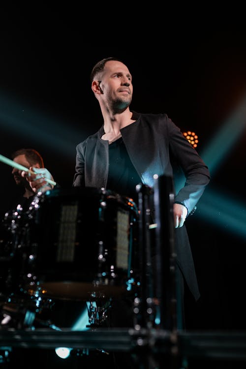 A Man Playing Drums at a Concert