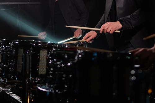 A Close-Up Shot of People Playing Drums