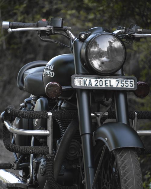 Free Close-up of a classic Royal Enfield motorcycle parked outdoors in Kumta, India. Stock Photo