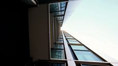 A Low Angle Shot of a Building with Glass Panels