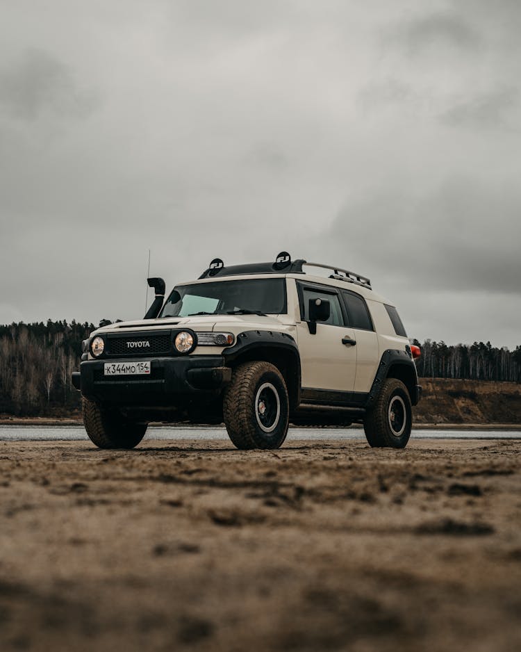 Modern SUV Automobile Parked At Seaside On Cloudy Day