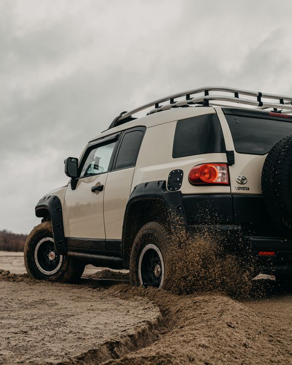 Car For Rough Road Riding Crossover car driving on rough sandy terrain on cloudy day · Free Stock ...