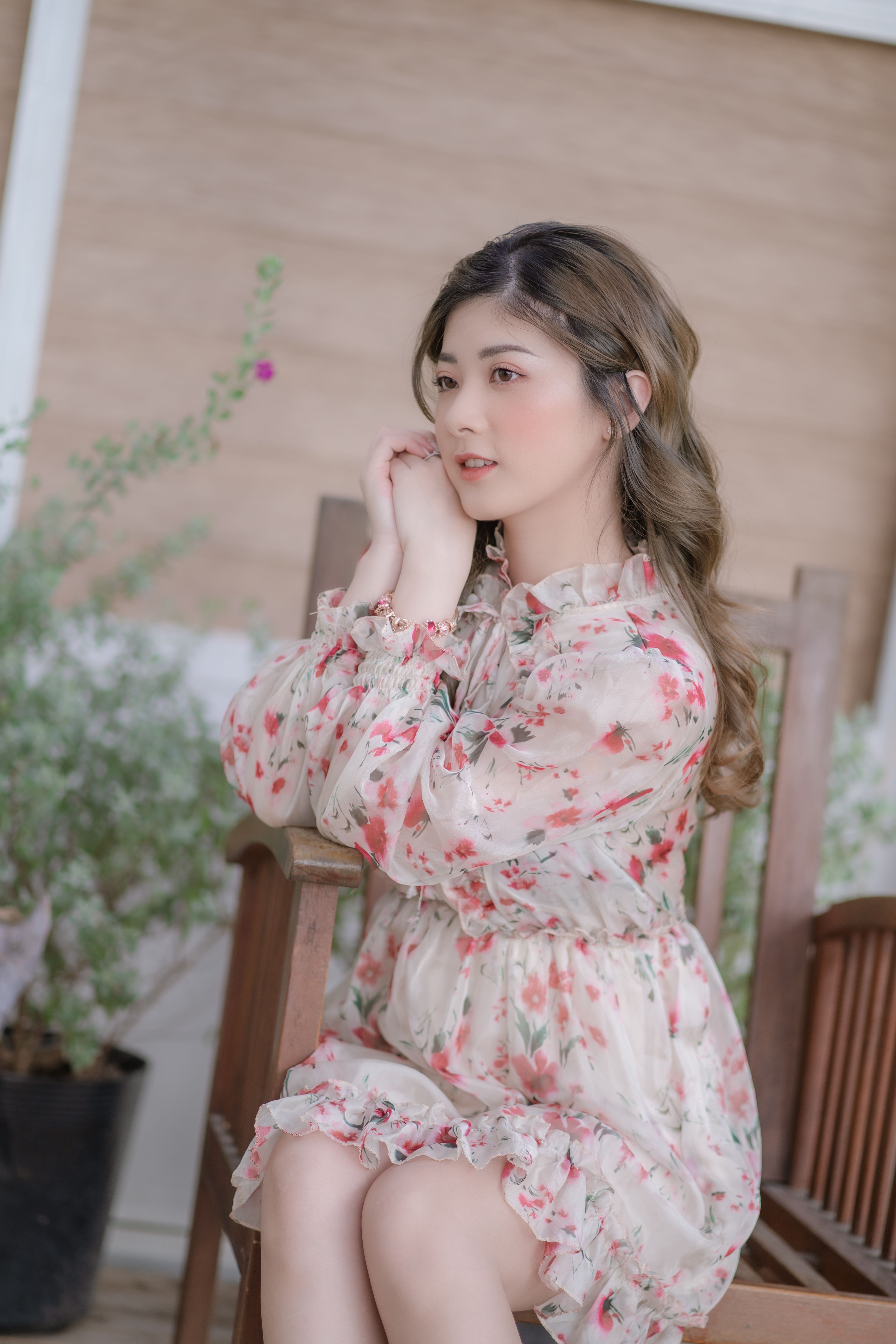 Beautiful Young Woman in a Floral Dress Sitting on a Chair · Free Stock ...