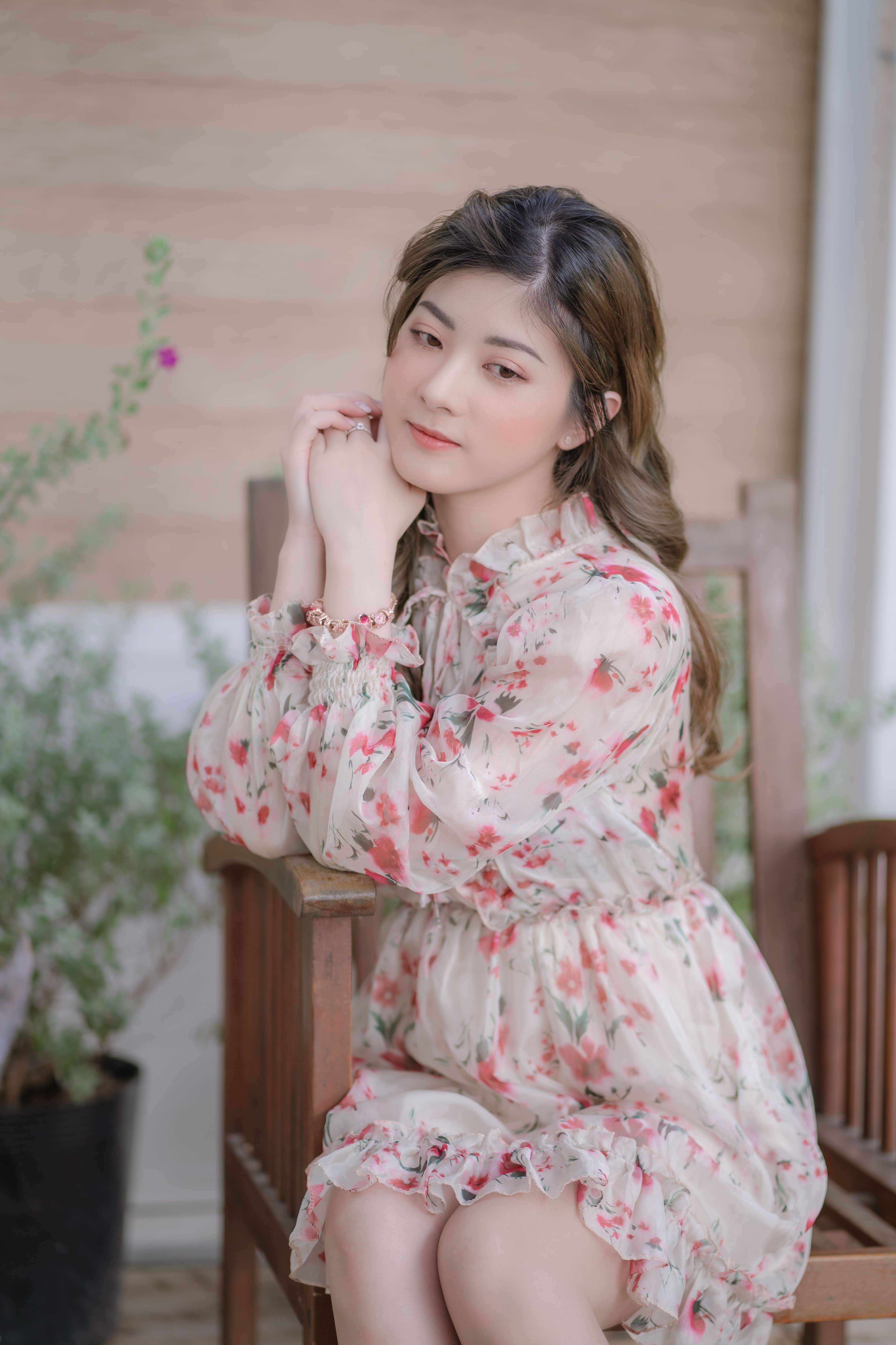 Photograph of a Woman in a Floral Dress Sitting on a Brown Chair · Free ...