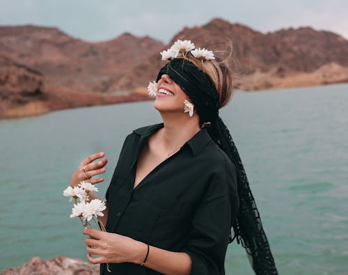 Free Blindfolded Woman Holding White Flowers Stock Photo