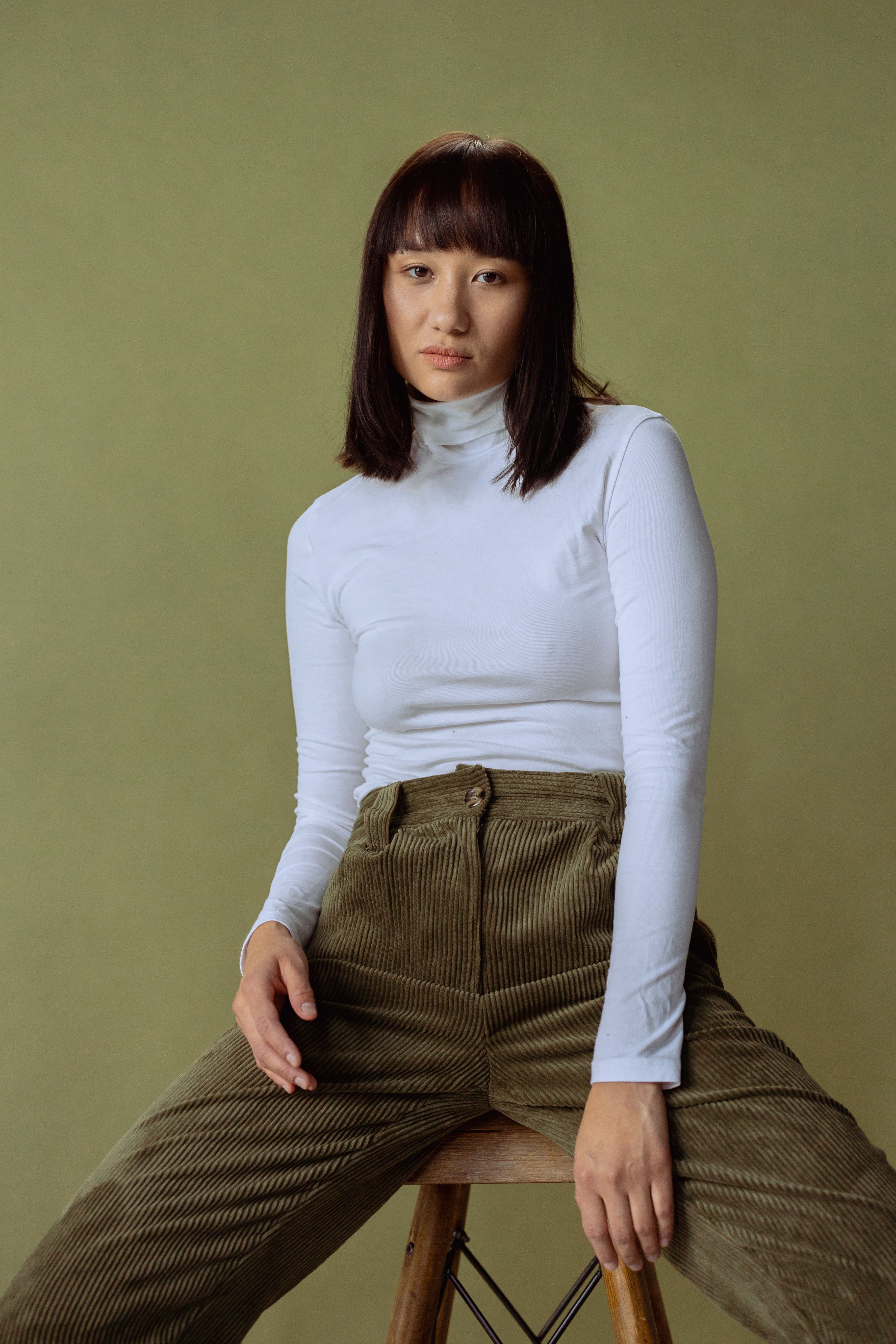 Woman in corduroy pants with a cream sweater