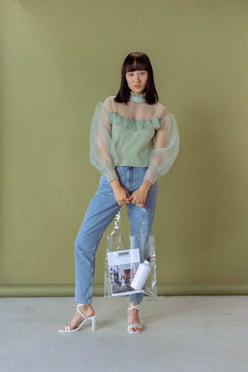 Free Photo of a Woman in a Green Top Holding a Clear Bag Stock Photo