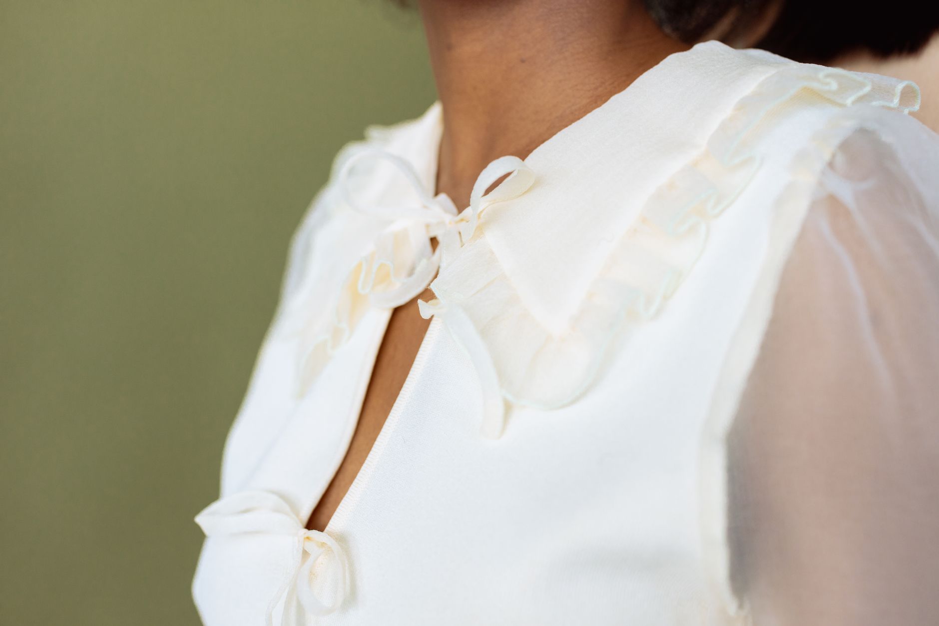 Close-up of a care label on a polyester blouse showing washing instructions