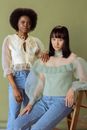 Photograph of Two Models in Blouses Looking at the Camera