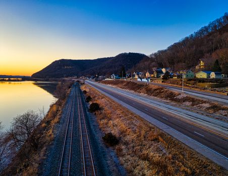 An aerial view of railway and highway by the Mississippi River in Minneiska at sunrise.