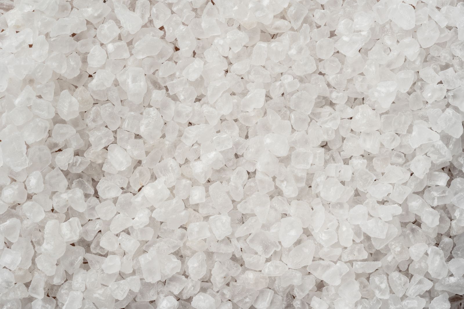 Coarse white sea salt crystals close up