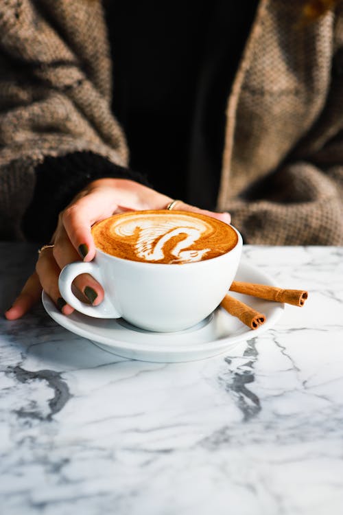 Free Person Holding a Cup of Coffee Stock Photo