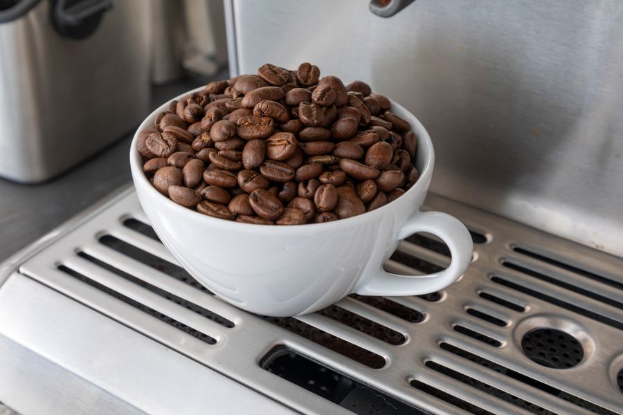 Bean to cup commercial coffee machine with a fresh espresso being poured