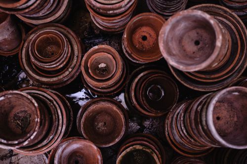 Free Explore rustic craftsmanship with stacked clay pots, highlighting earthy textures and tones. Stock Photo