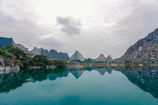 Peaceful scene of mountains reflecting in a lake in Haiphong, Vietnam.