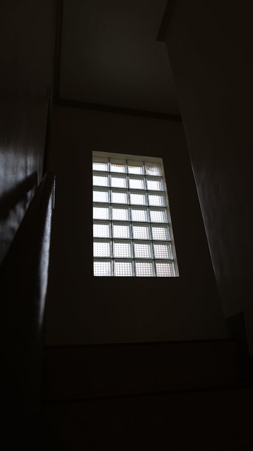Low Angle Photo of Glass Window on a Dark Room 