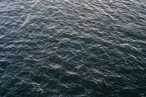 Free Captivating aerial view of rippled ocean surface with dark blue hue. Stock Photo