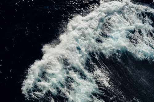 Free Dynamic aerial shot of ocean waves crashing, capturing the raw power and beauty of nature. Stock Photo
