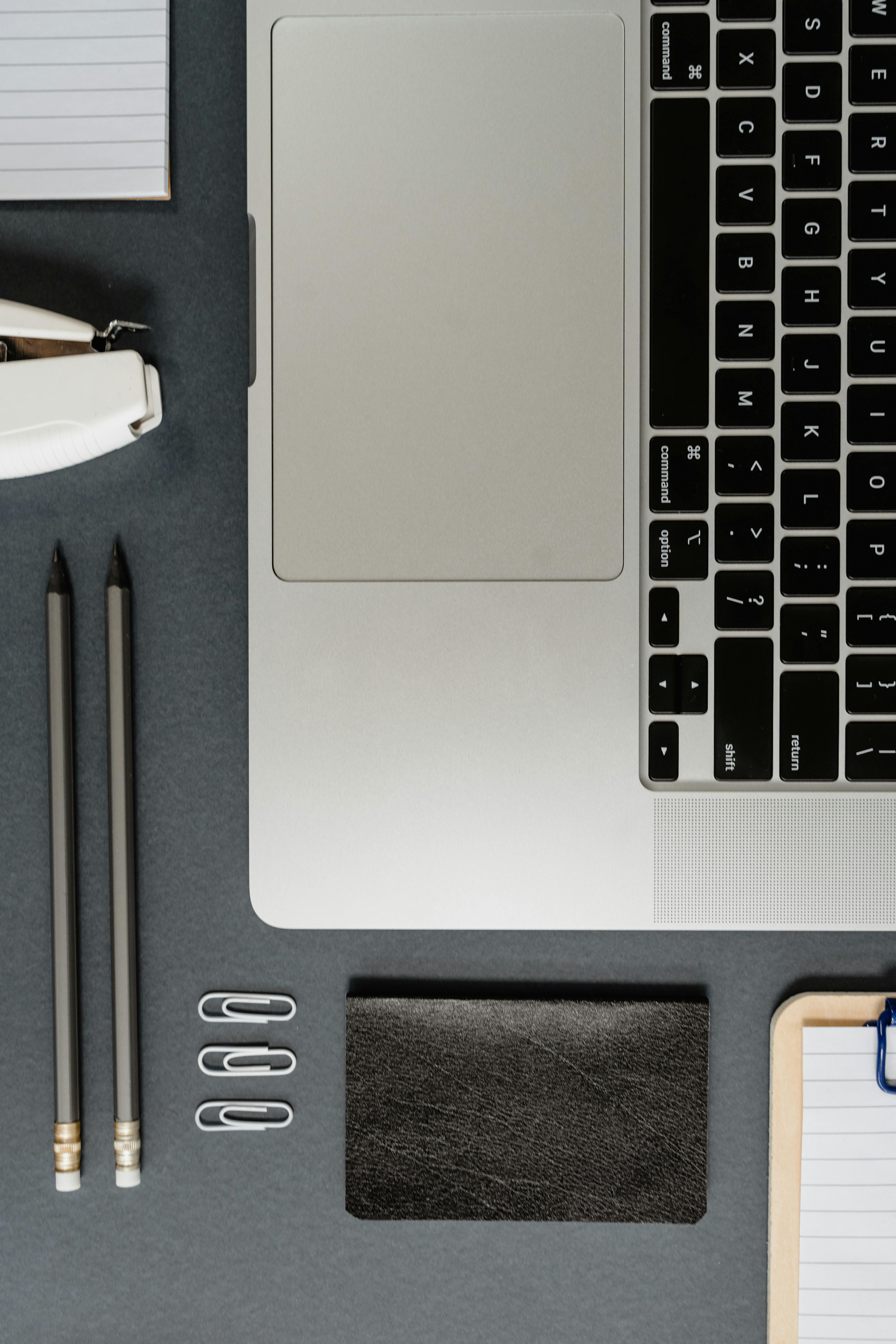 a flatlay of a laptop and office supplies