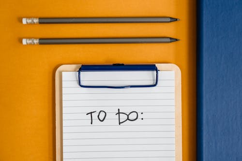 Pencils and To-do List on Yellow Table