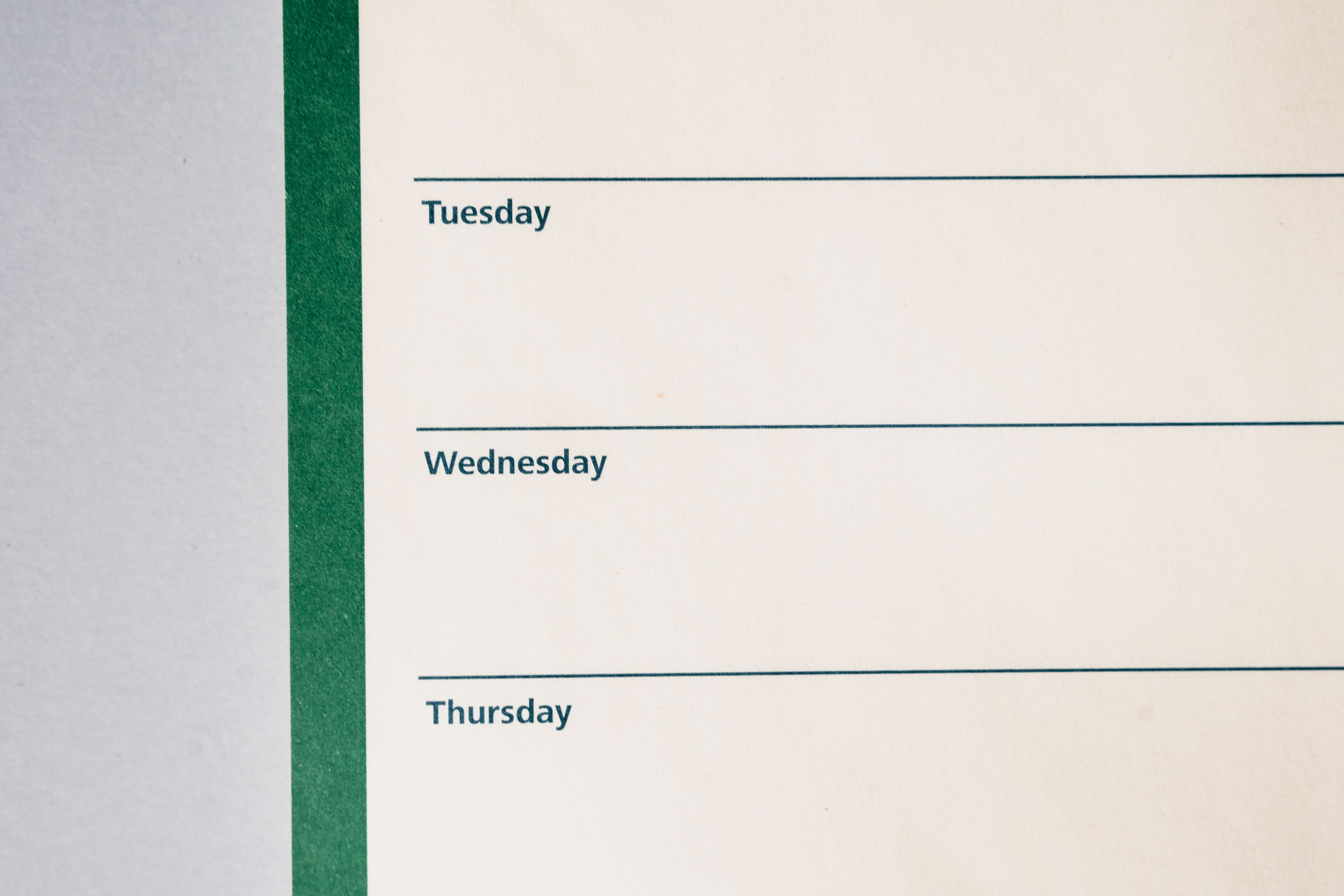 Close-up view of a minimalist weekly planner featuring days of the week.