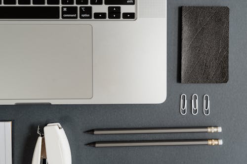 Free Stationery and Laptop on Gray Background Stock Photo